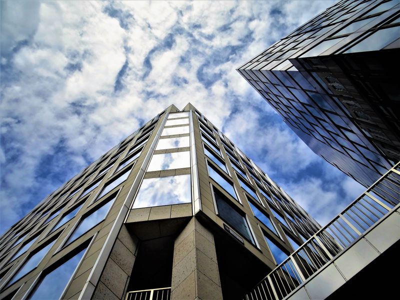Modern tower with a glass facade reflecting the sky