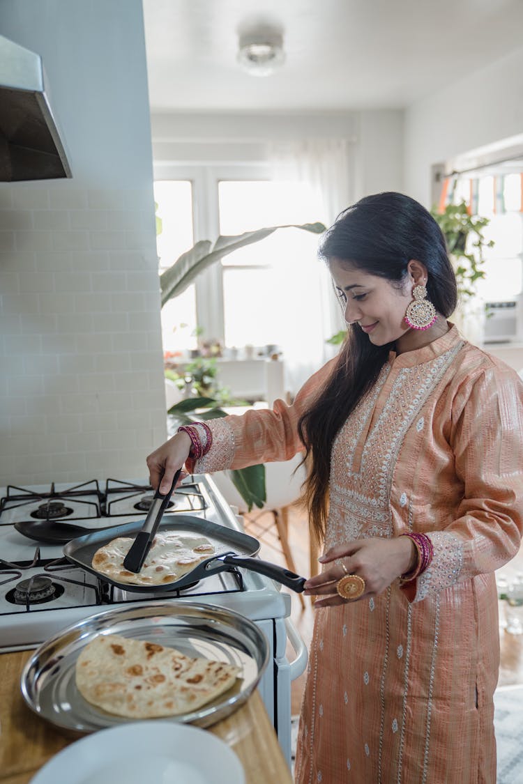 A Woman Heating Flatbread