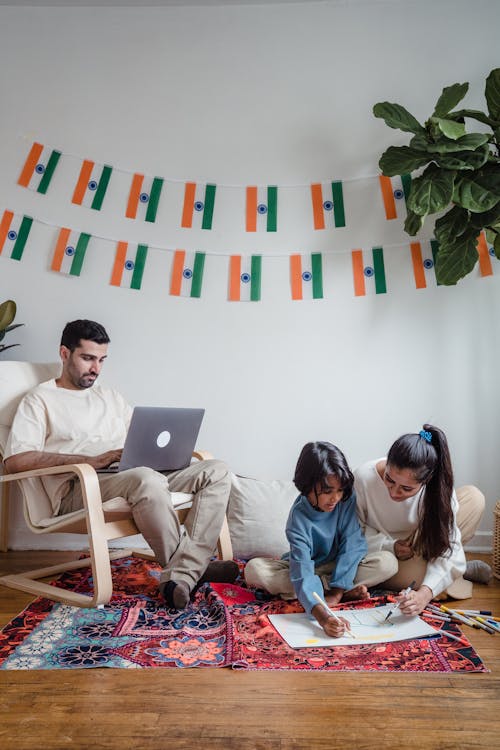 Free Man and Woman Sitting on Bed Using Macbook Stock Photo