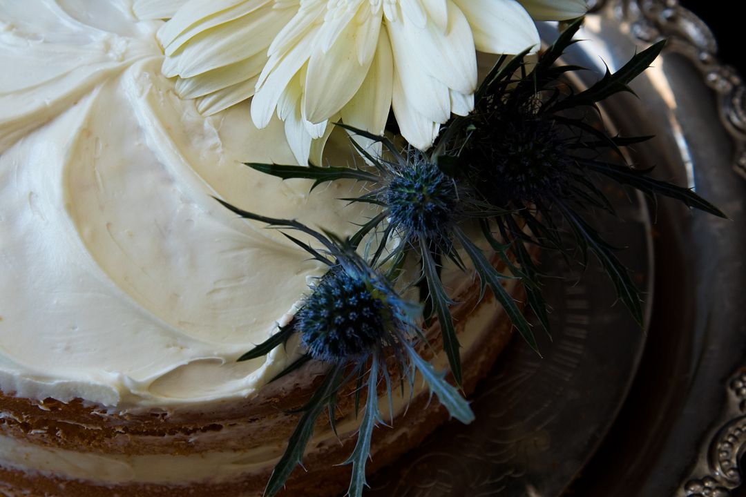 White Flowers on Round Cake With White Cream