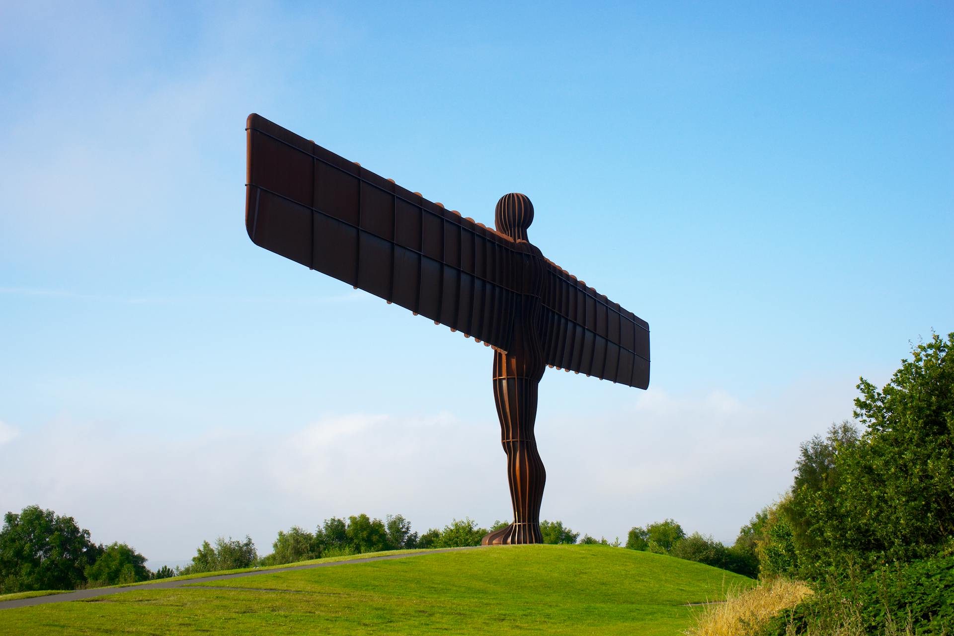 Iconic Angel of the North statue in Newcastle against a clear blue sky.