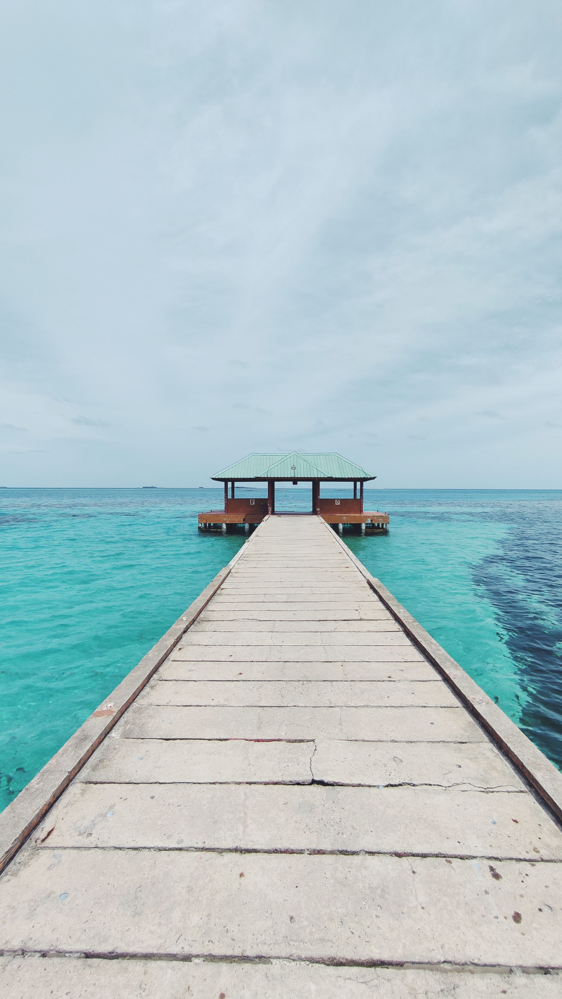 Wooden jetty over turquoise sea