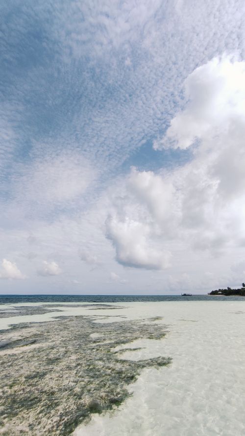 Free Peaceful beach view in Dhangethi, Maldives, showcasing clear sky and calm ocean waters. Stock Photo