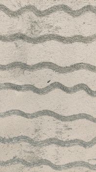Concrete wall featuring a close-up view of wavy texture pattern, ideal for backgrounds and design elements.