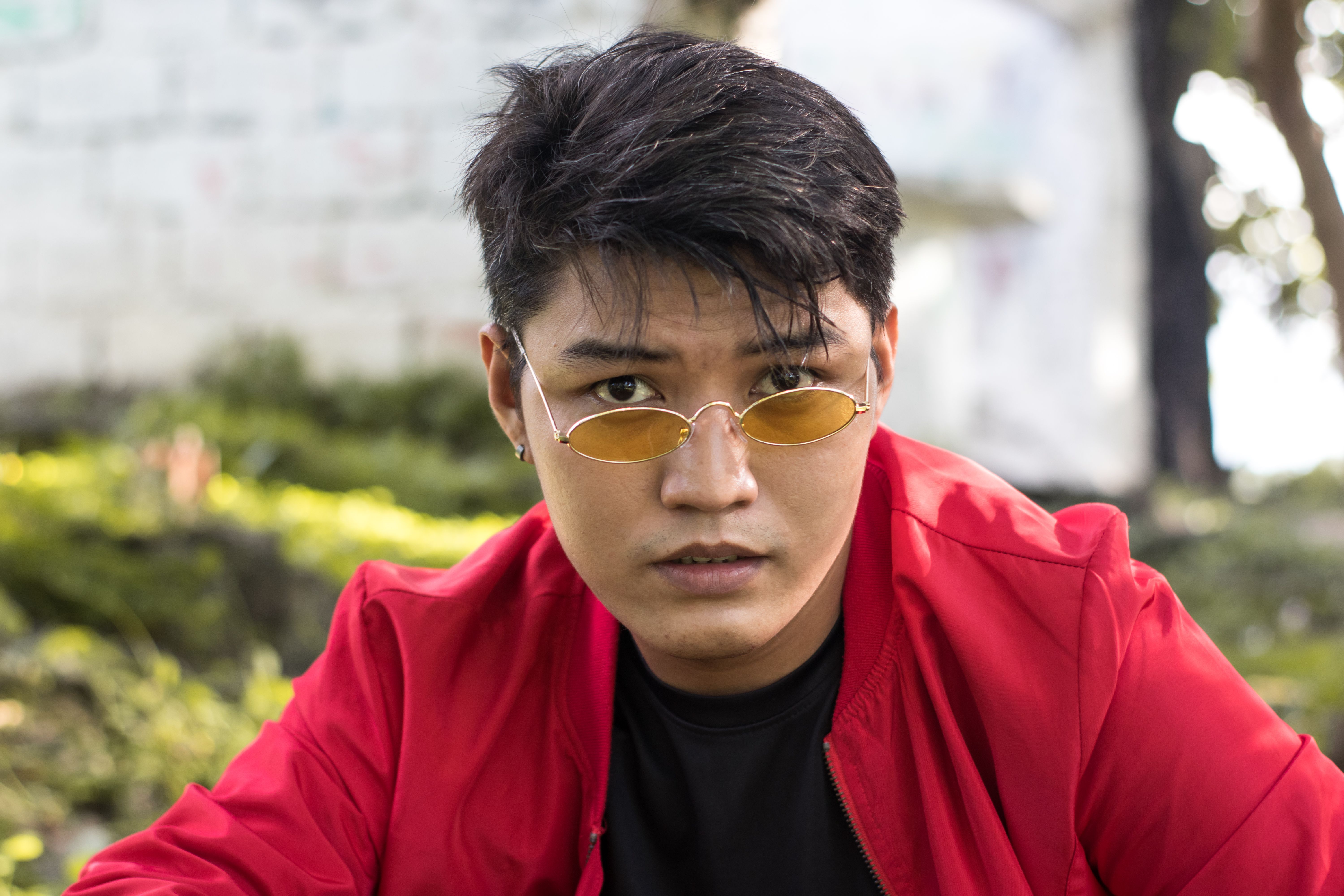 Portrait of a man wearing sunglasses and a red jacket in a park, Muntinlupa.