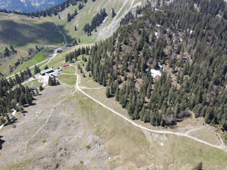 Explore the stunning aerial view of Schliersee's lush greenery and rugged mountain terrain.
