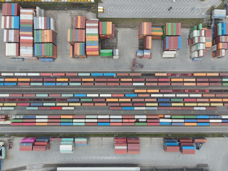 warehouse manager reviewing freight emissions data on tablet