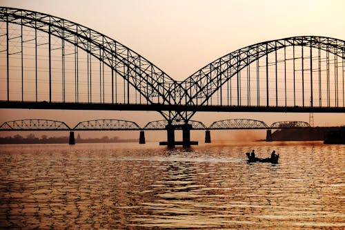 Black Metal Bridge Near on Body of Water