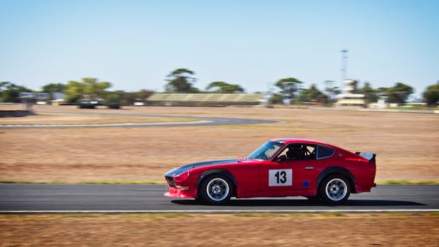 Red and Black Sports Coupe on Road at Daytime