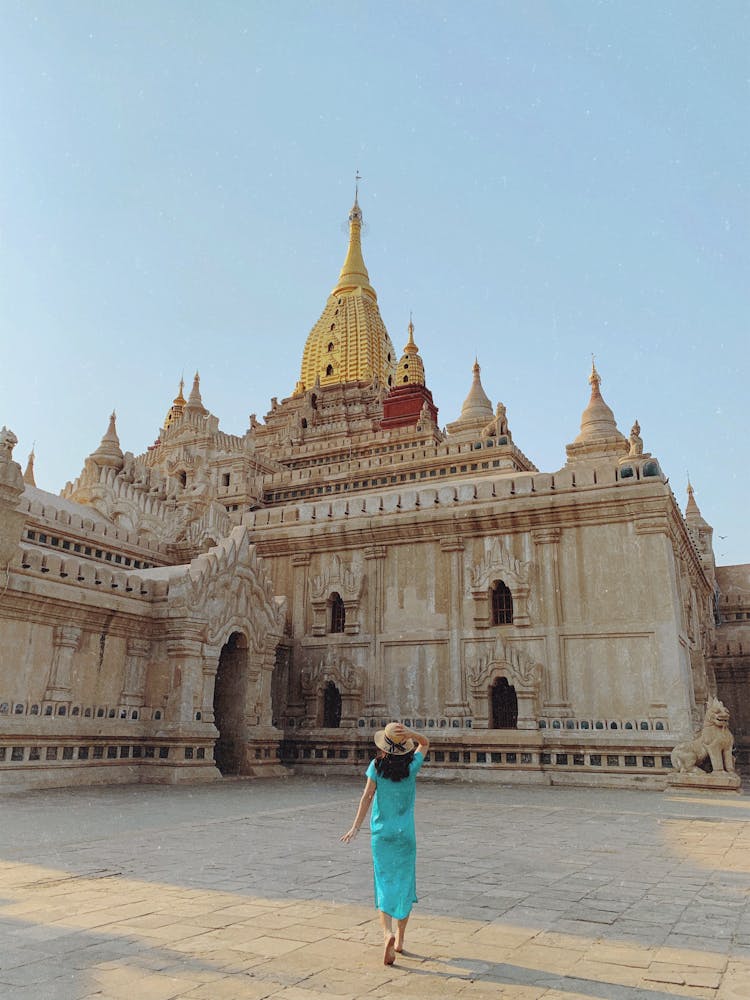 Back View Of A Woman Walking Towards The Ananda Temple