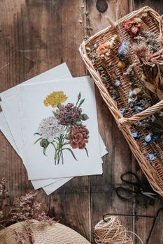 Vintage floral illustration surrounded by dried flowers in a rustic setting.. vintage, floral, illustration