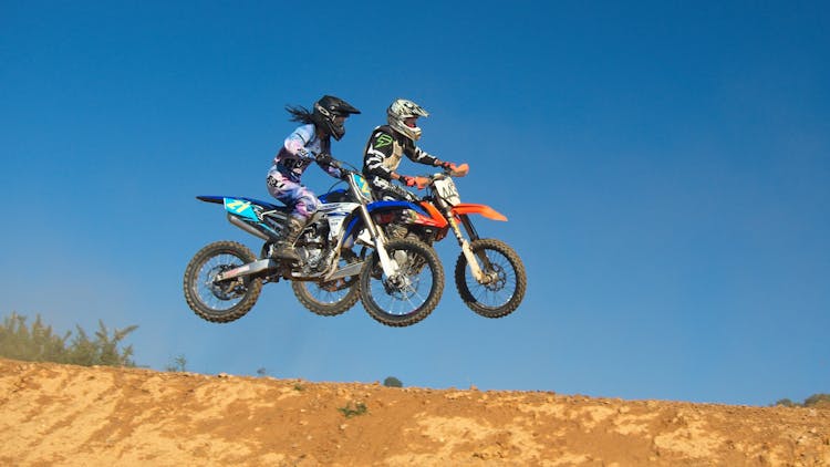 Two Person Riding Motocross Dirt Bikes