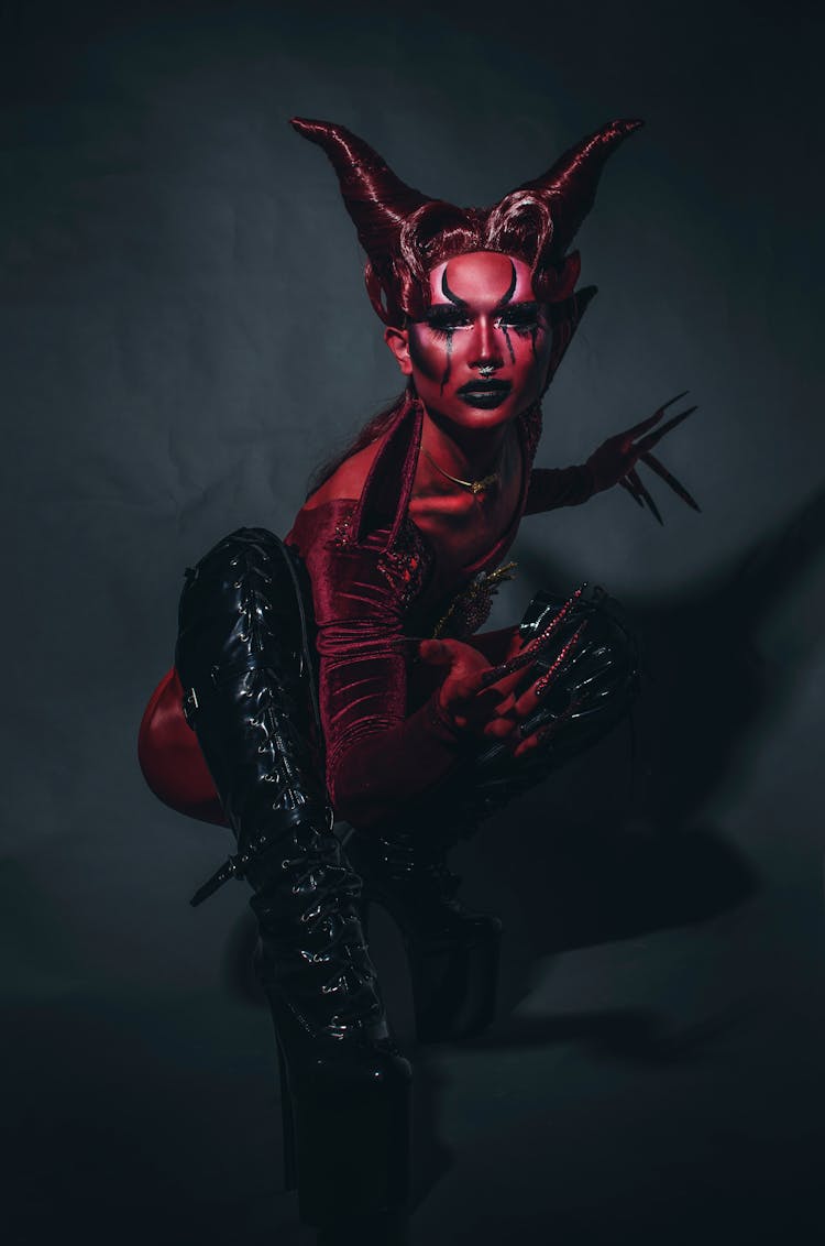 Crouching Fashion Model Disguised As Black And Red Devil 