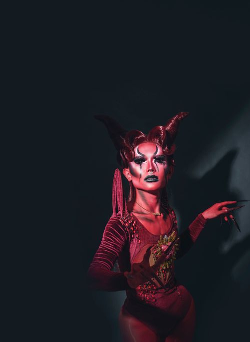 Free Striking portrait of a person in elaborate costume with dramatic lighting and makeup. Stock Photo