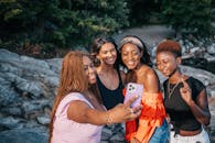3 Women and 2 Men Smiling While Taking Photo
