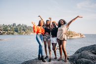 Female Friends standing on a Boulder