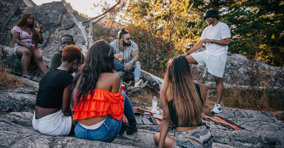 Friends On The Rocks Friends Sitting on Rocks · Free Stock Photo