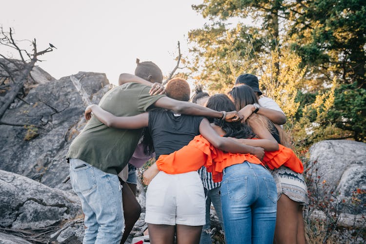 A Group Of People Standing Outdoors