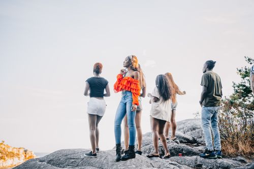 Free A group of stylish friends exploring a rocky landscape during summer. Stock Photo