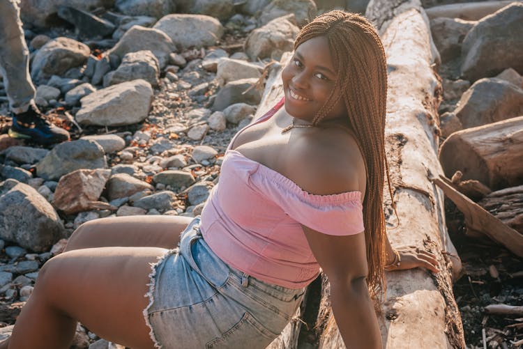 A Woman Sitting On A Log