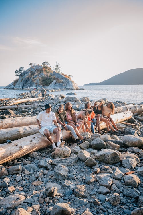 Free Photo of People Sitting on a Tree Log Stock Photo