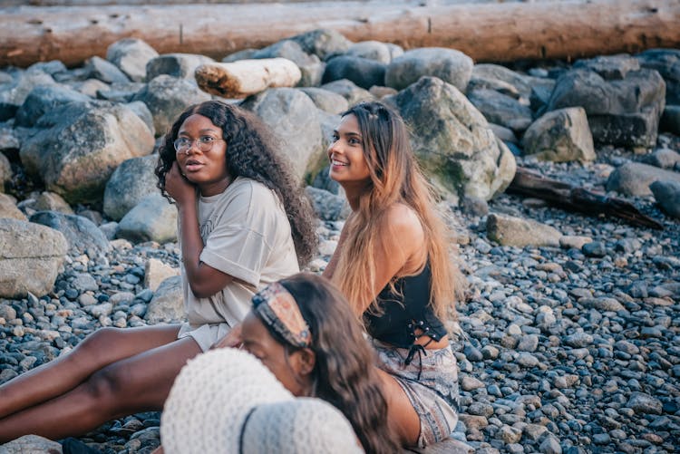 Two Women Sitting On The Rocks 