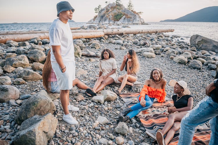 Friends Chatting Beside The Ocean