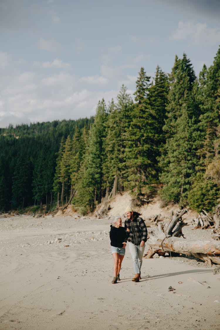 A Couple Walking On The Shore