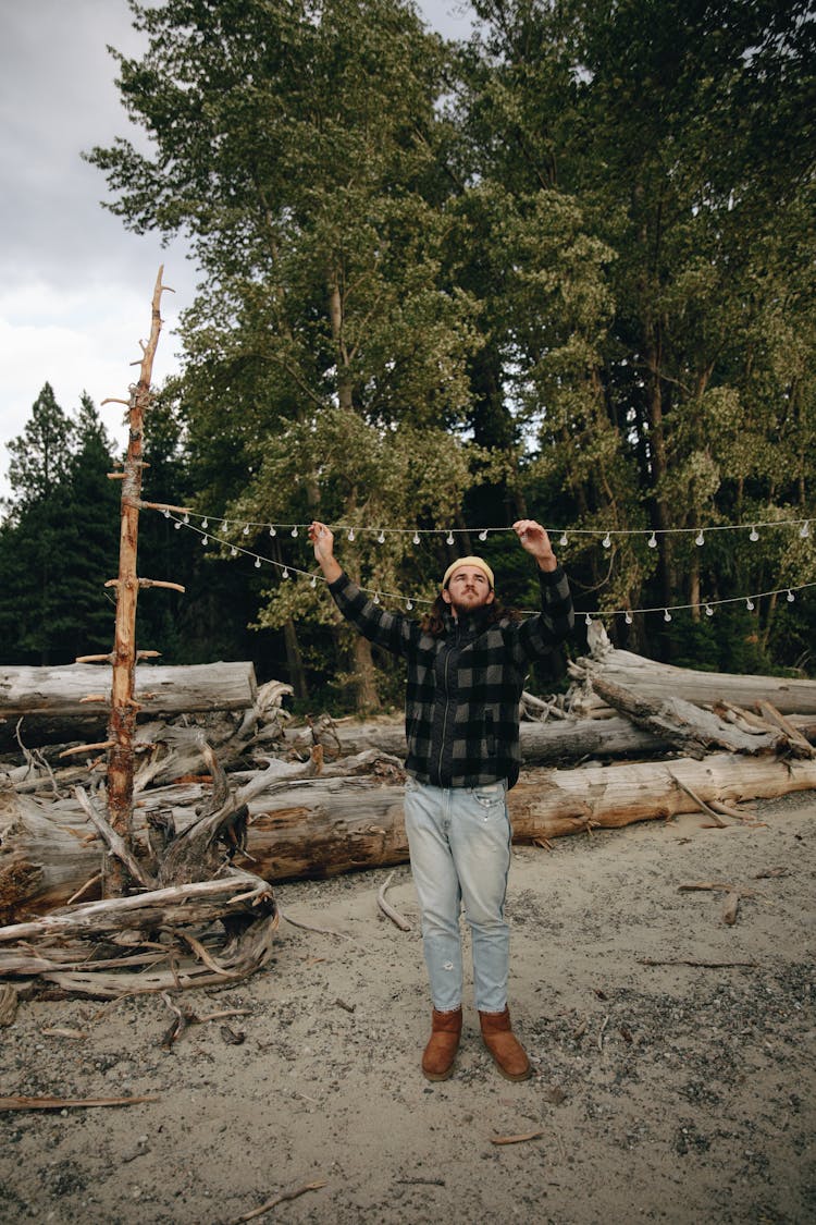 A Man Putting Lights On The Camping Area