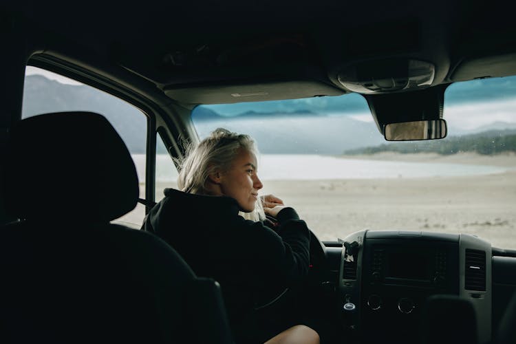 A Woman Driving A Car