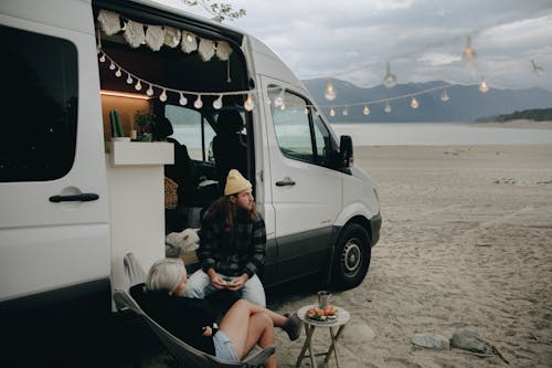 Free A Couple Sitting by an RV Stock Photo