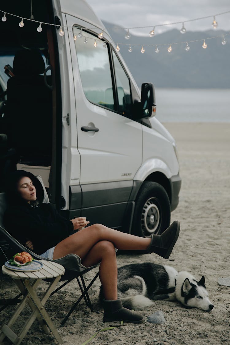 A Woman Living A Van Life With Her Dog