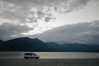 White Campervan Parked on a Seashore