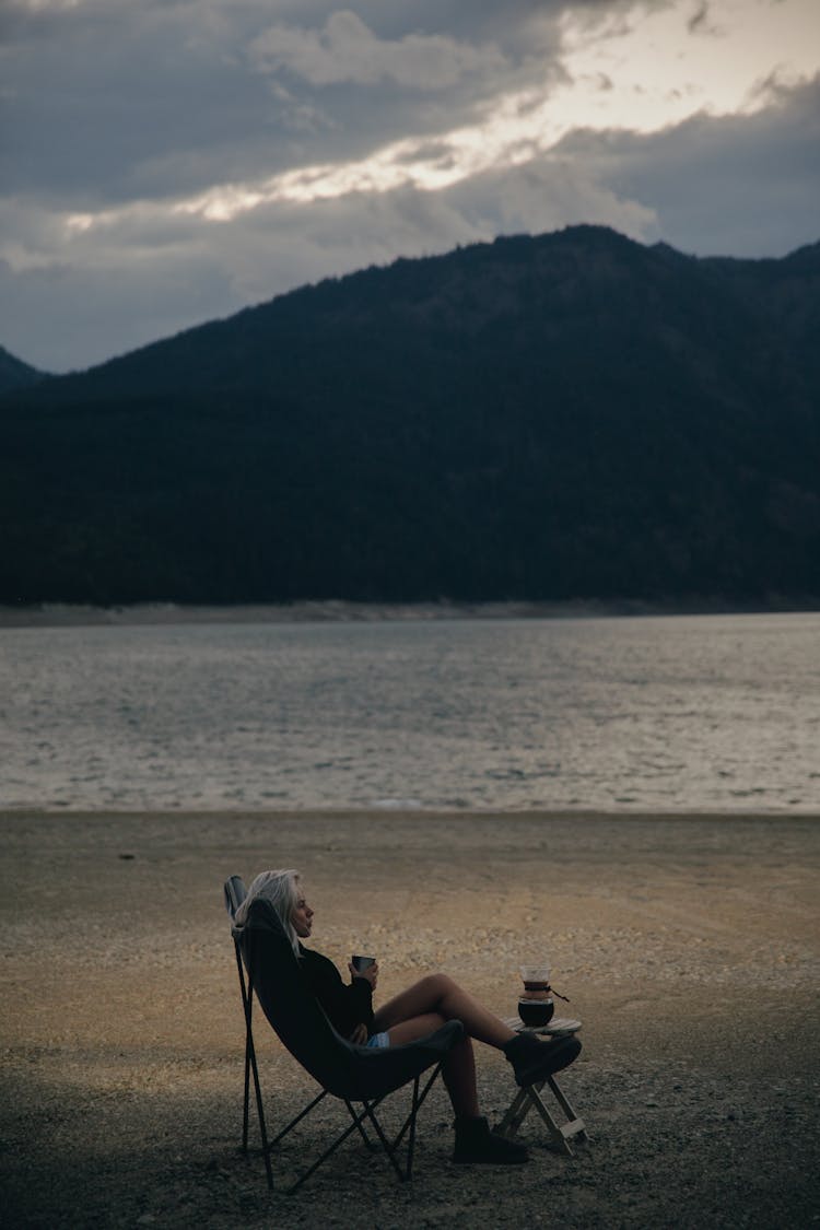 A Woman Sitting On The Camping Chair