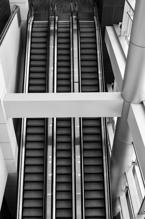 Grayscale Photo of Escalator