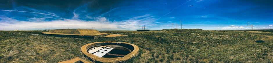 Panoramic view of an abandoned missile silo under a clear blue sky in Deer Trail, Colorado.