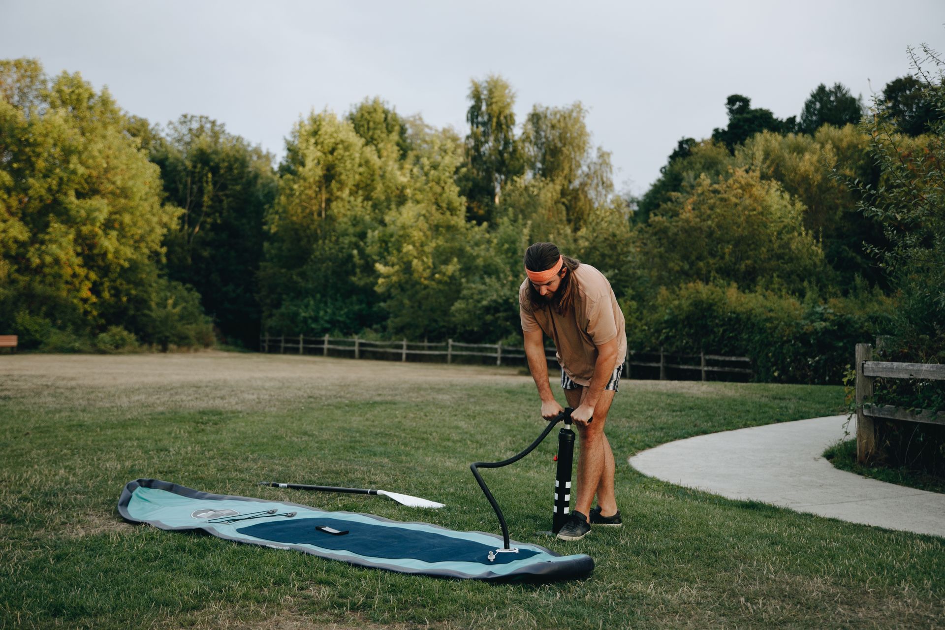 Man Inflating a SUP Board