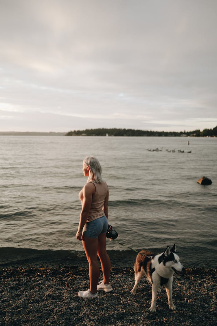 Woman With Dog On Beach