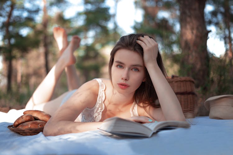 Girl Lying In Lacy Underwear And Reading Book