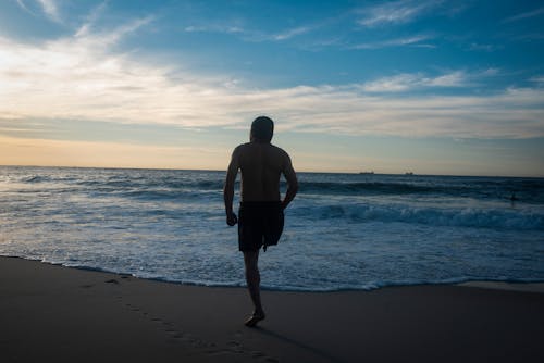 Man with One Leg on Beach