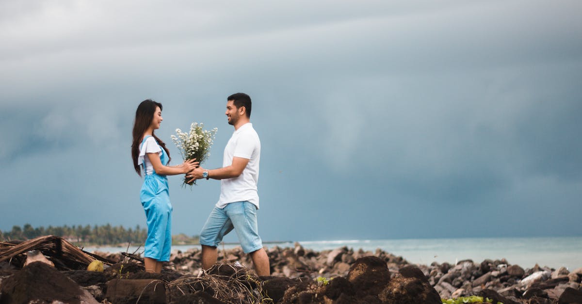 Photo of Man Giving Flowers to Woman