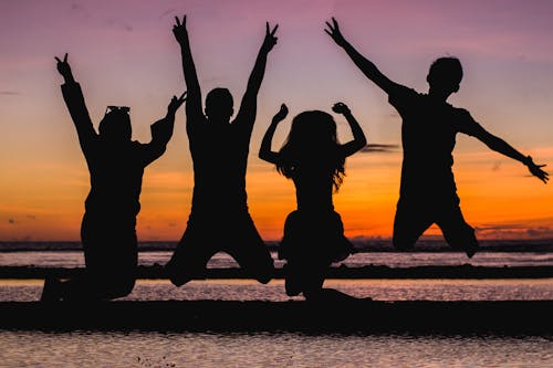 Silhouette of People Jumping