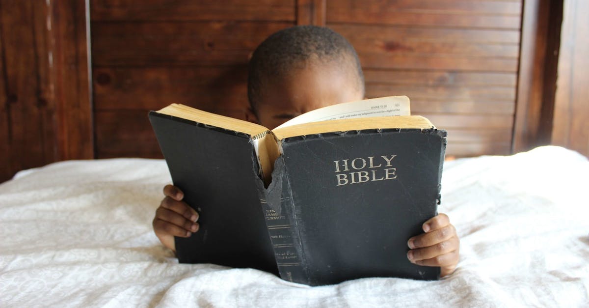 Photo of Child Reading Holy Bible