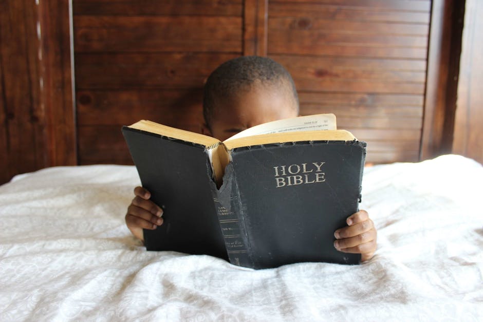 Photo of Child Reading Holy Bible