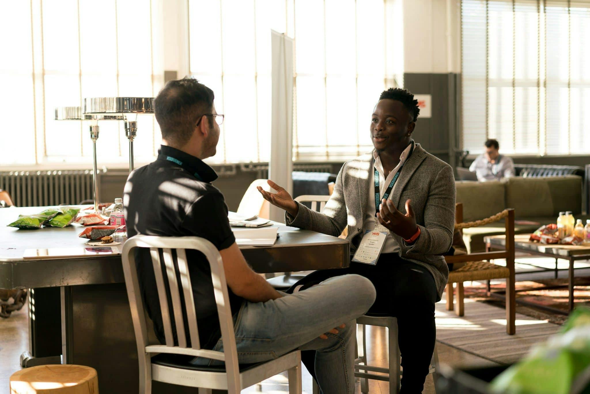 Two men having conversation. | Photo: Pexels