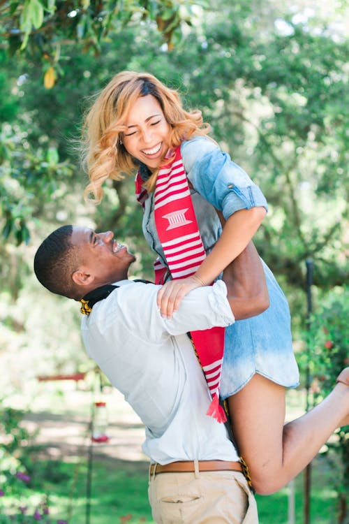 Free Photo of Man Lifting Woman Near Tree Stock Photo