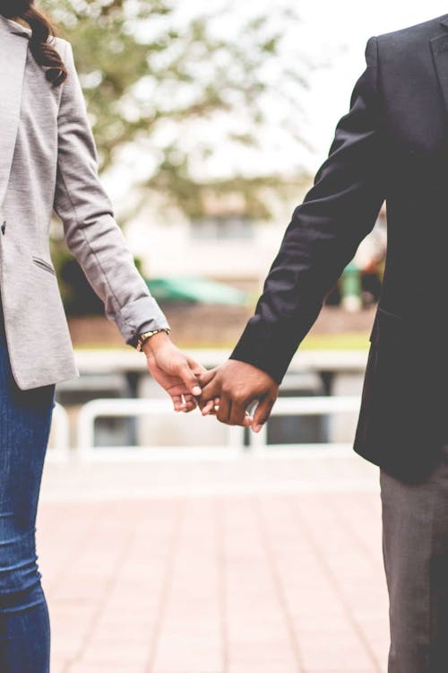 Free Man and Woman Holding Hands Stock Photo