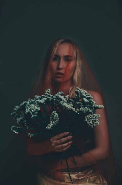 A Woman Holding White Flowers