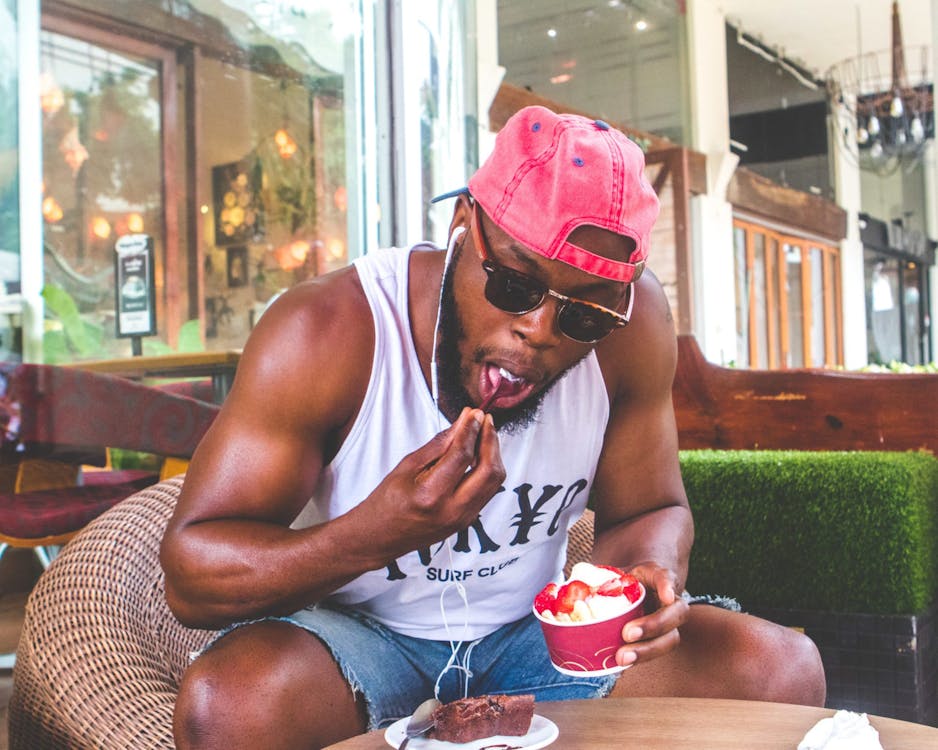 Free Man Eating Froyo With Strawberries Stock Photo