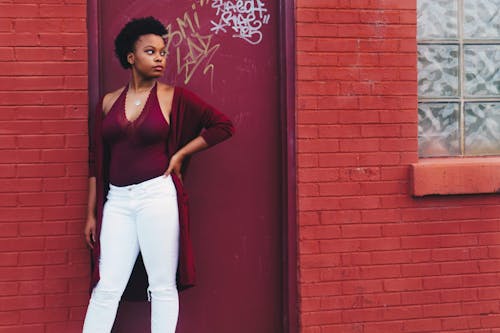 Woman in Red Halter Top and White Pants